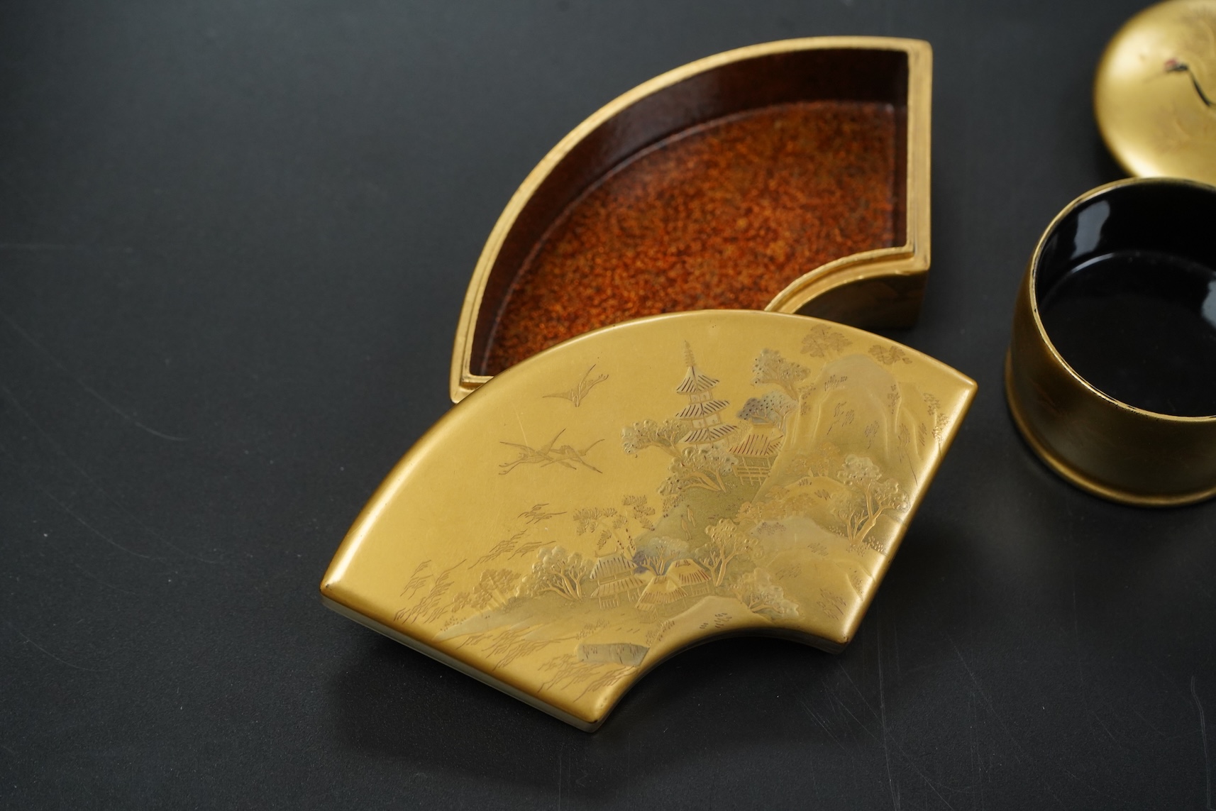 Three Japanese gilt lacquer boxes, one depicting Mount Fuji, largest 9cm wide